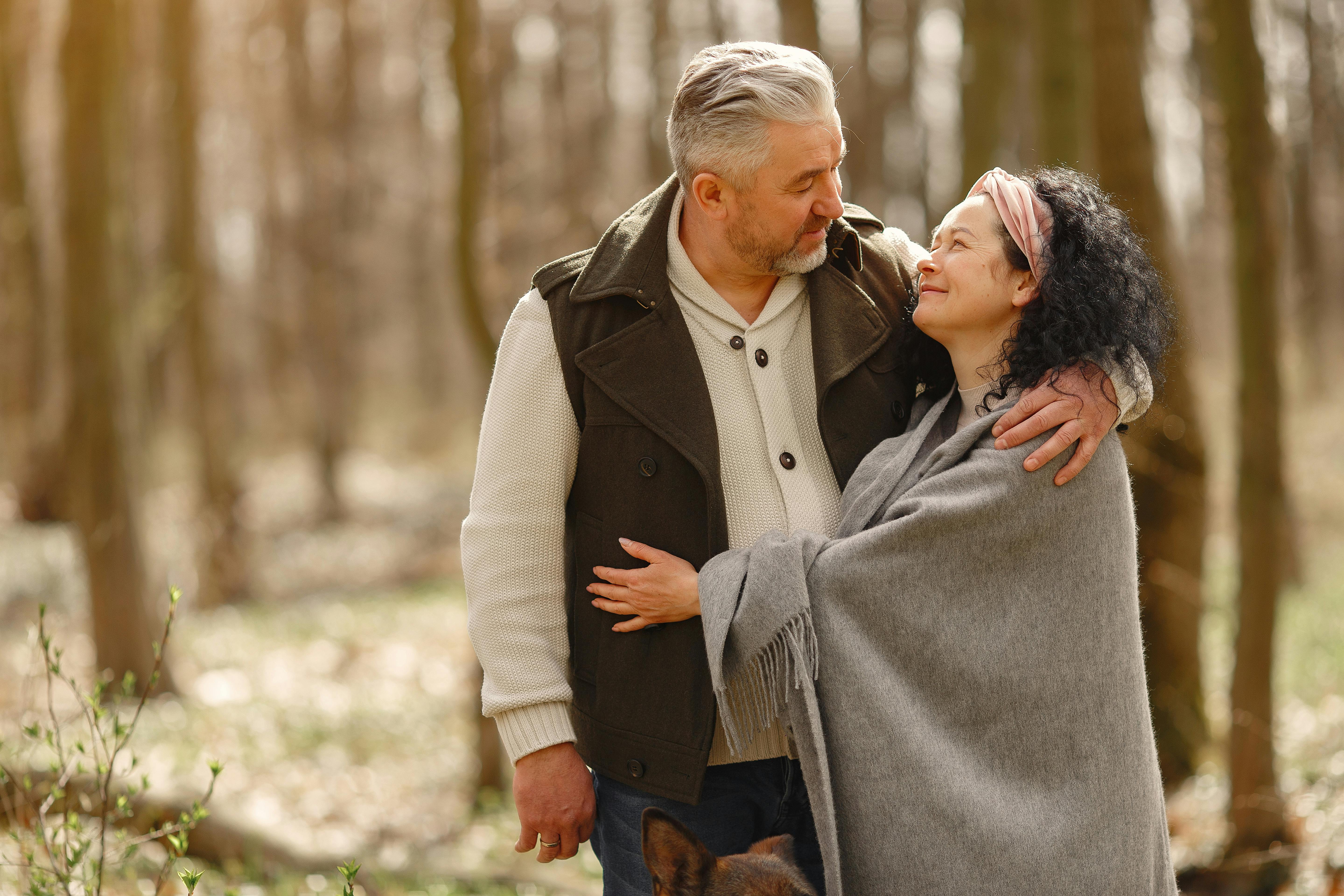 man and woman couple hug in forest