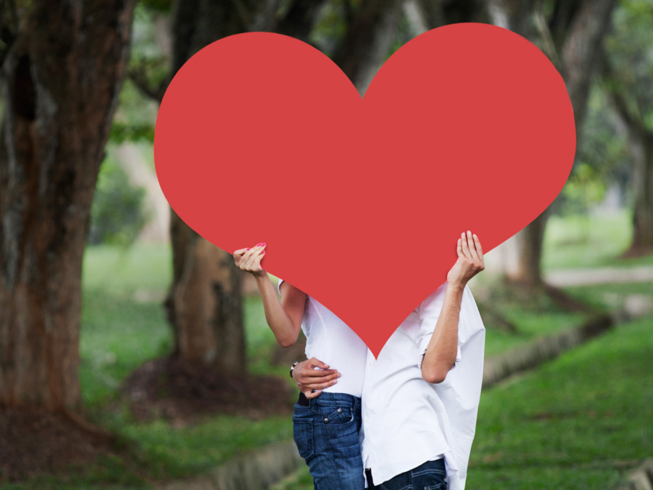 couple holding a giant red heart