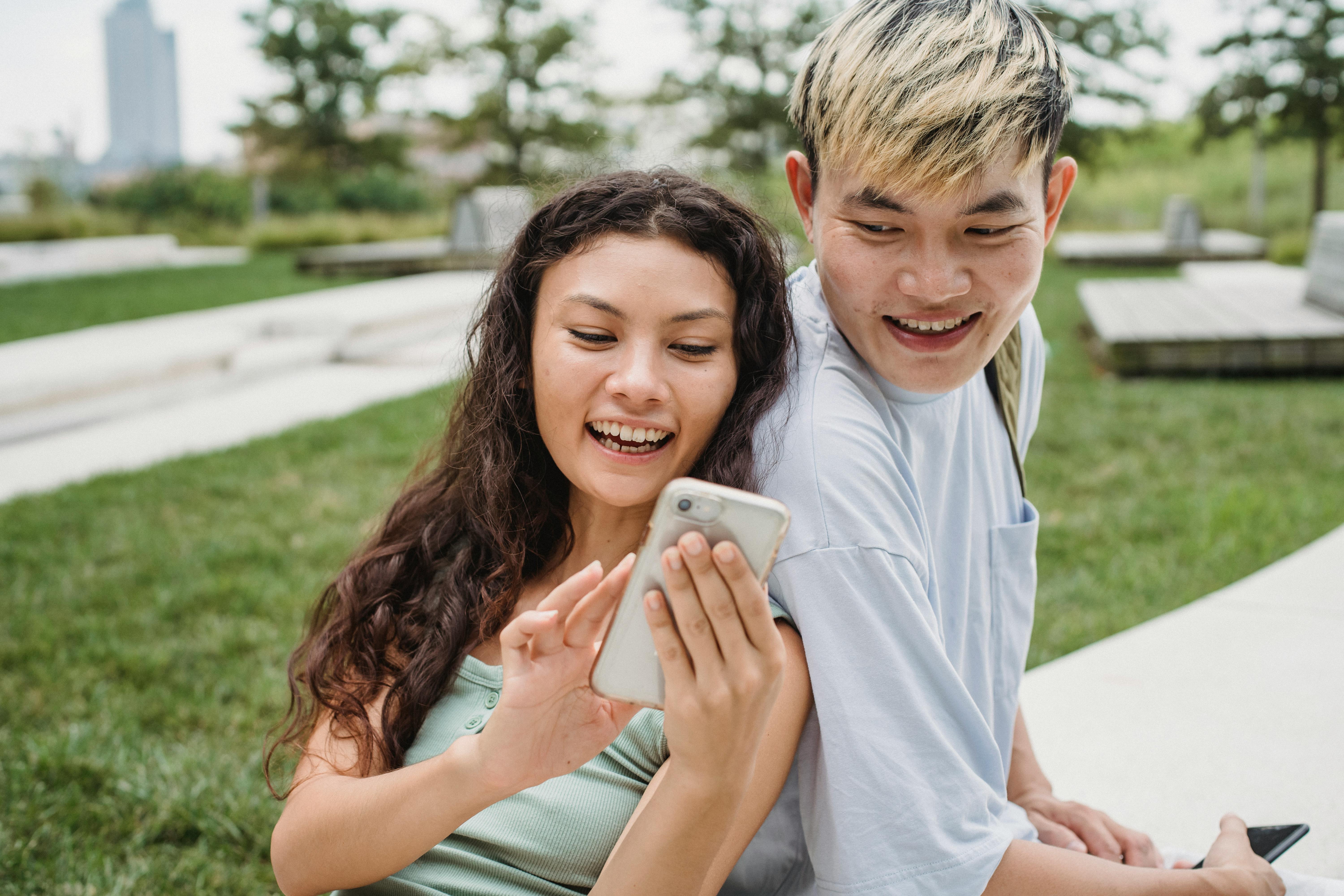 girl and boy looking at phone
